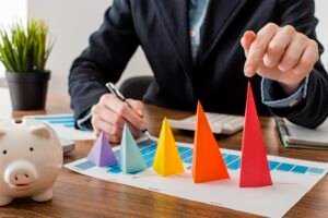 Fractional marketing leader analyzing colorful cone graphs on a growth chart at a modern desk setup.